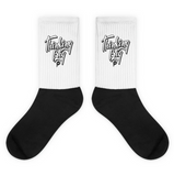 mockup image of 'Thinking Big Script' design on black and white crew socks