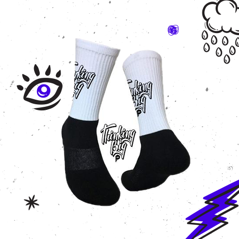 mockup image of 'Thinking Big Script' design on black and white crew socks